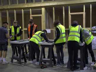 A group of apprentices at CES working wearing high vis jackets.