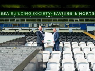 Alun Williams, Chief Executive of Swansea Building Society, (left) unveils 2025/26 shirt with Lee Merrells, Head of Partnerships at Swansea City AFC.